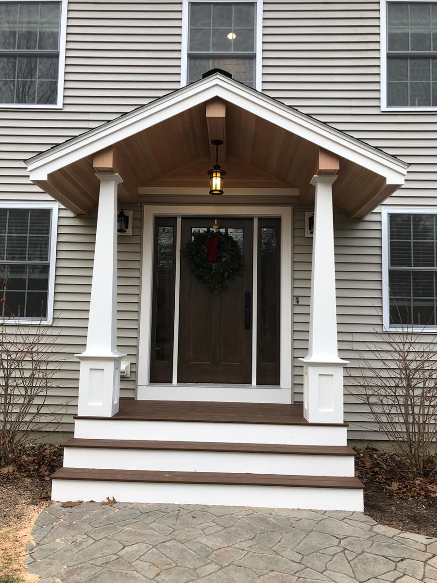 Exterior of house with new front porch entryway and stone walkway
