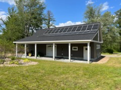Garage addition with solar panels and landscaping