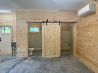 Newly remodeled garage with pine floors and sliding barn door