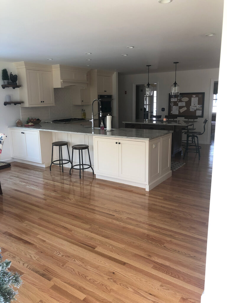 Interior shot of recently remodeled kitchen with custom counters, cabinets, and granite countertops